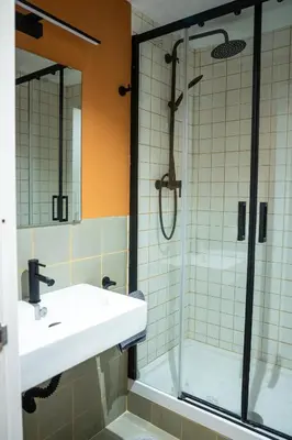 a bathroom with a sink and a shower at Onefam Paralelo in Barcelona