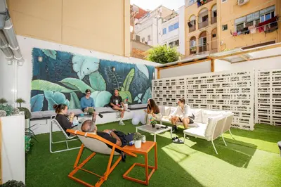 a group of people sitting in chairs on a rooftop at Onefam Paralelo in Barcelona