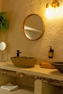 a bathroom with a sink and a mirror on the wall at Cal Mestre Casa Rural in Avinyonet