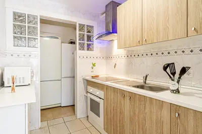 a kitchen with a sink and a refrigerator at Residencial Costamar next Bcn, 50m beach with swimming pool in Cabrera de Mar