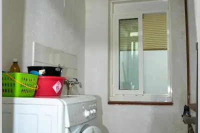 a kitchen with a washing machine and a window at Residencial Costamar next Bcn, 50m beach with swimming pool in Cabrera de Mar