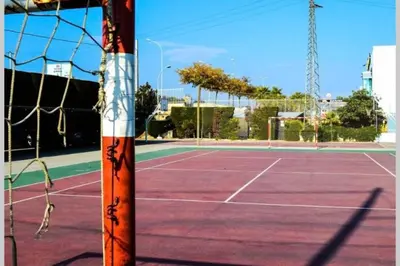 a tennis court with a net on top of it at Residencial Costamar next Bcn, 50m beach with swimming pool in Cabrera de Mar