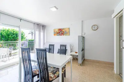 a dining room with a white table and chairs at Residencial Costamar next Bcn, 50m beach with swimming pool in Cabrera de Mar
