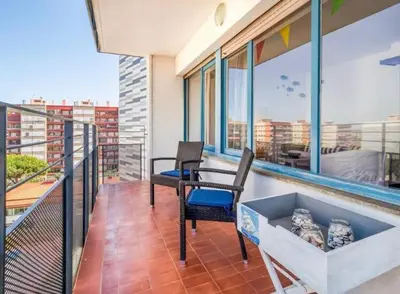 a balcony with two chairs and a table on a building at Can Mabi, 30' Bcn next beach in Vilassar de Mar