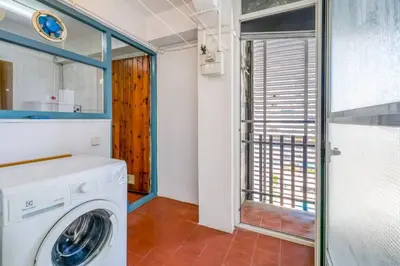 a laundry room with a washing machine and a window at Can Mabi, 30' Bcn next beach in Vilassar de Mar