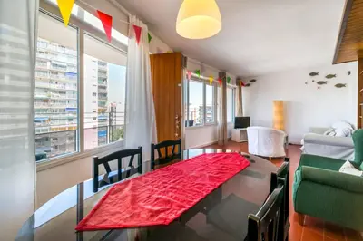 a living room with a table with a red rug at Can Mabi, 30' Bcn next beach in Vilassar de Mar