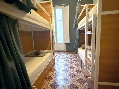 a room with two bunk beds and a tile floor at Fabrizzio's Petit in Barcelona