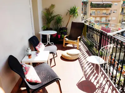 a balcony with chairs and tables on a building at Fabrizzio's Petit in Barcelona