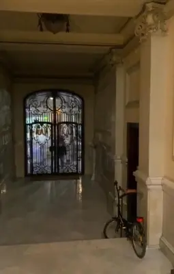 a bike parked in a room with a glass door at Barcelona Central Apartments in Barcelona