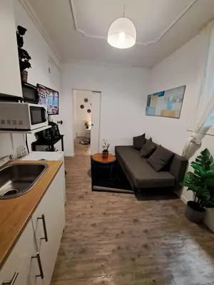 a kitchen and a living room with a couch at Barcelona Central Apartments in Barcelona