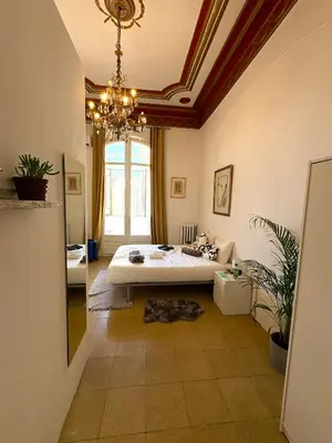 a bedroom with a bed and a chandelier at Barcelona Central Apartments in Barcelona