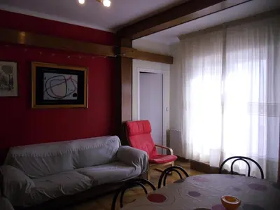 a living room with a couch and a table at Atico Soleado Vistas panoramicas in Hospitalet de Llobregat