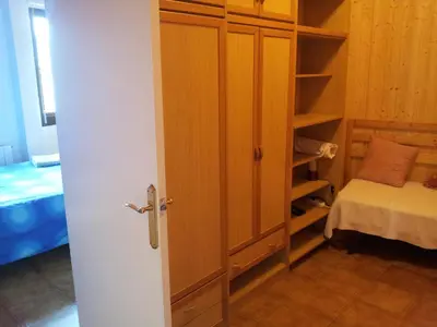 a door to a room with a closet and a bed at Atico Soleado Vistas panoramicas in Hospitalet de Llobregat