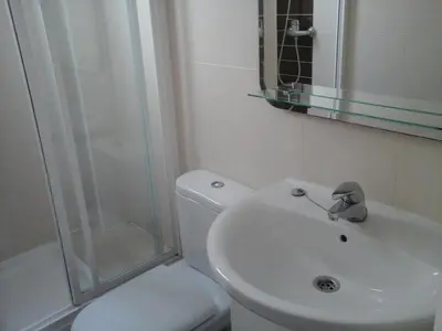 a bathroom with a toilet and a sink and a shower at Atico Soleado Vistas panoramicas in Hospitalet de Llobregat