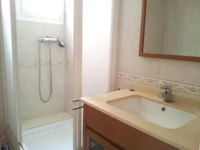 a bathroom with a sink and a shower at Atico Soleado Vistas panoramicas in Hospitalet de Llobregat