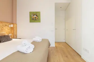 a bedroom with a bed with towels on it at Chic and Modern Apartments in Gracia in Barcelona