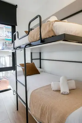 two bunk beds in a room with a bed at Chic and Modern Apartments in Gracia in Barcelona
