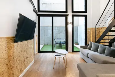 a living room with a couch and a tv at Chic and Modern Apartments in Gracia in Barcelona
