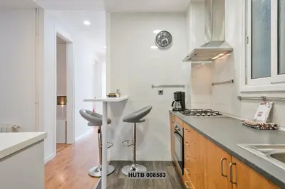 a white kitchen with a counter and a sink at Alcam Berlin-Numancia in Barcelona