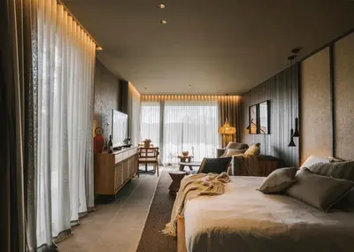 a hotel room with a large bed and a television at Les Cabanes de l'Oller del Mas in Manresa