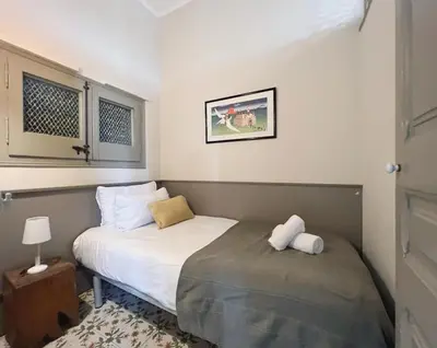 a small bedroom with a bed and a window at Stay U-nique Apartments Borbó II in Barcelona