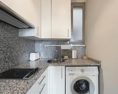 a kitchen with a washing machine and a sink at Stay U-nique Apartments Borbó II in Barcelona