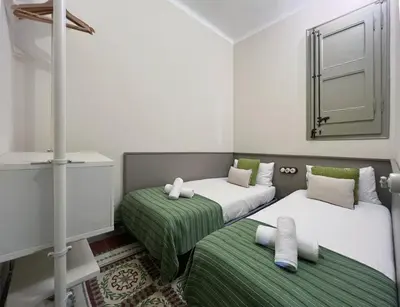 a room with two beds and a mirror on the wall at Stay U-nique Apartments Borbó II in Barcelona