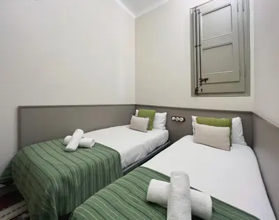 a room with two beds and a mirror at Stay U-nique Apartments Borbó II in Barcelona