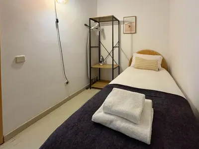 a small room with a bed with a mirror and a mirror at Stay U-nique Apartments Borbó in Barcelona