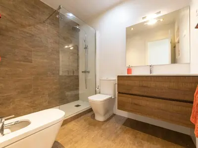 a bathroom with a toilet and a shower and a sink at Holiday Home Aeris by Interhome in Cunit