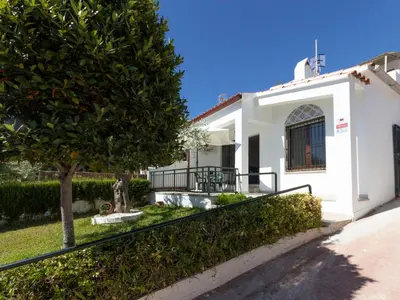 a white house with a tree and a fence at Holiday Home Aeris by Interhome in Cunit