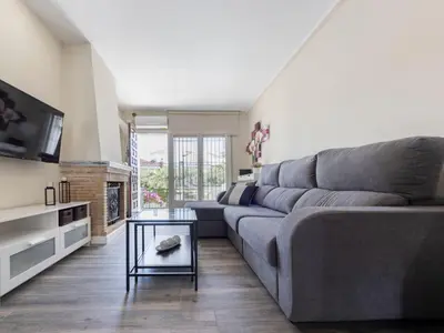 a living room with a gray couch and a table at Holiday Home Aeris by Interhome in Cunit