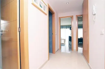 a hallway of a room with doors and a room with a hallway at Apartamentos Sitges in Sitges