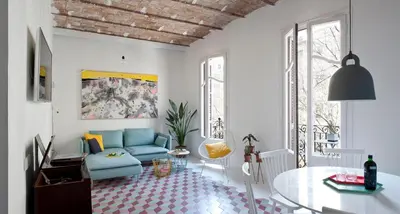 a living room with a blue couch and a table at Tyche apartment in Barcelona