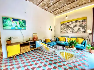 a living room with a couch and a table at Tyche apartment in Barcelona