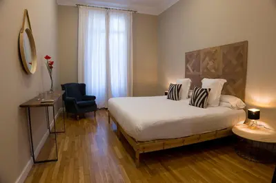 a hotel room with a bed and a chair at Cami Gallery Barcelona in Barcelona