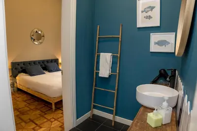 a bathroom with a bed and a sink in a room at Cami Gallery Barcelona in Barcelona