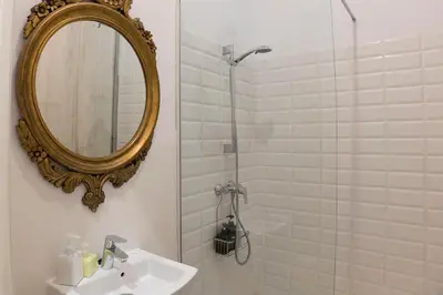 a bathroom with a mirror and a sink and a shower at Cami Gallery Barcelona in Barcelona