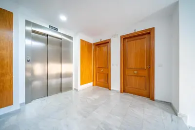 an empty hallway with two doors and a tile floor at HomeHolidaysRentals Adara in Pineda de Mar