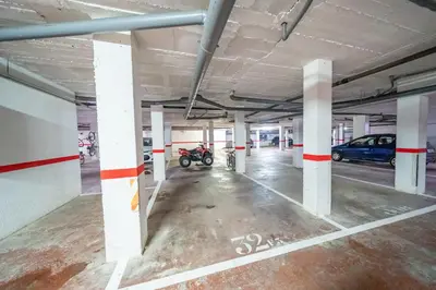 an empty parking garage with a motorcycle parked in it at HomeHolidaysRentals Adara in Pineda de Mar