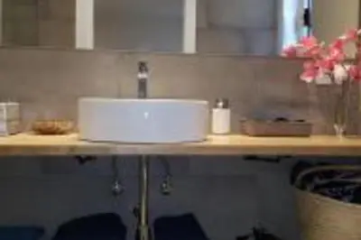 a bathroom counter with a sink with a faucet at Lovely Sea view Apartment in Gava in Gavà