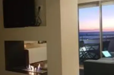 a living room with a television and a view of the ocean at Lovely Sea view Apartment in Gava in Gavà