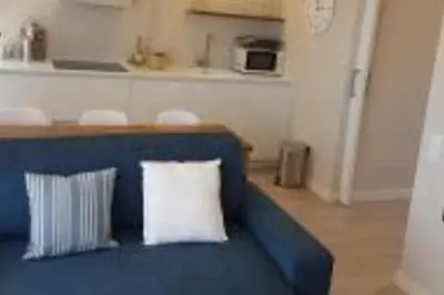 a blue couch with two pillows in a living room at Lovely Sea view Apartment in Gava in Gavà