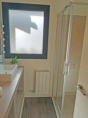 a bathroom with a shower and a sink and a window at Premium Habitat La Plana in Argentona