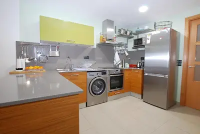a kitchen with a stainless steel refrigerator and a dishwasher at Petit niu · Petit niu · Apartamento AC - 3 min de la playa in Vilassar de Mar