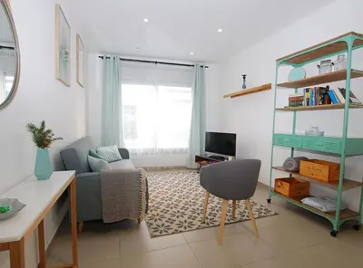 a living room with a couch and a chair at Petit niu · Petit niu · Apartamento AC - 3 min de la playa in Vilassar de Mar