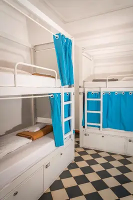 two bunk beds in a room with a checkered floor at Soul Backpackers Barcelona in Barcelona