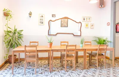 a dining room with a wooden table and chairs at Soul Backpackers Barcelona in Barcelona