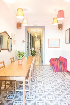 a dining room with a wooden table and chairs at Soul Backpackers Barcelona in Barcelona
