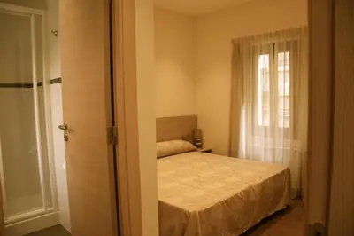 a small bedroom with a bed and a window at Hostal Excellence in Barcelona